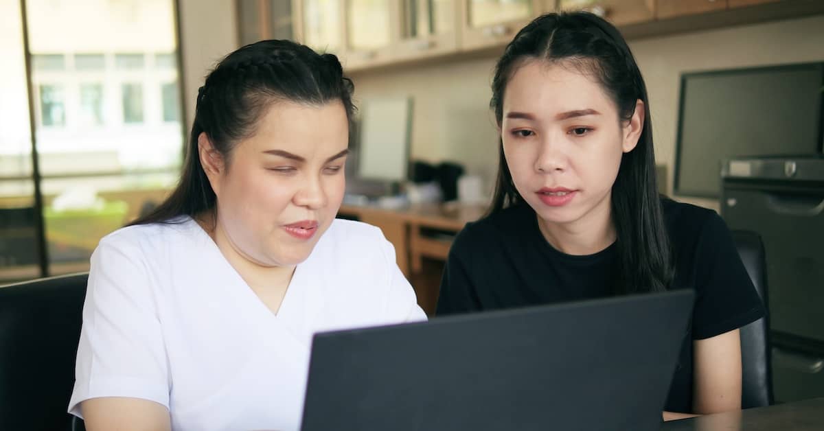 Daughter helping her blind mother access information on a computer screen | TPD Compensation Lawyers